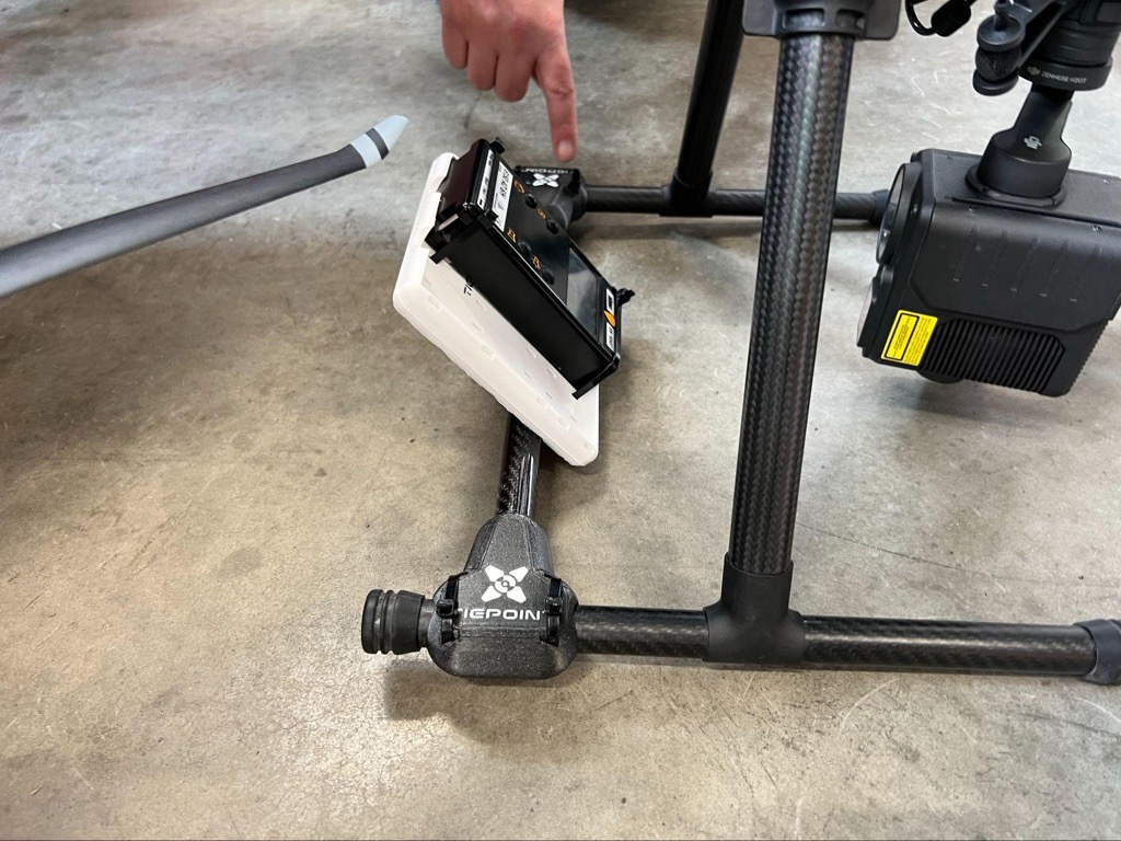 Handheld CBRNE sensor mounted in a 3D-printed holder on a drone